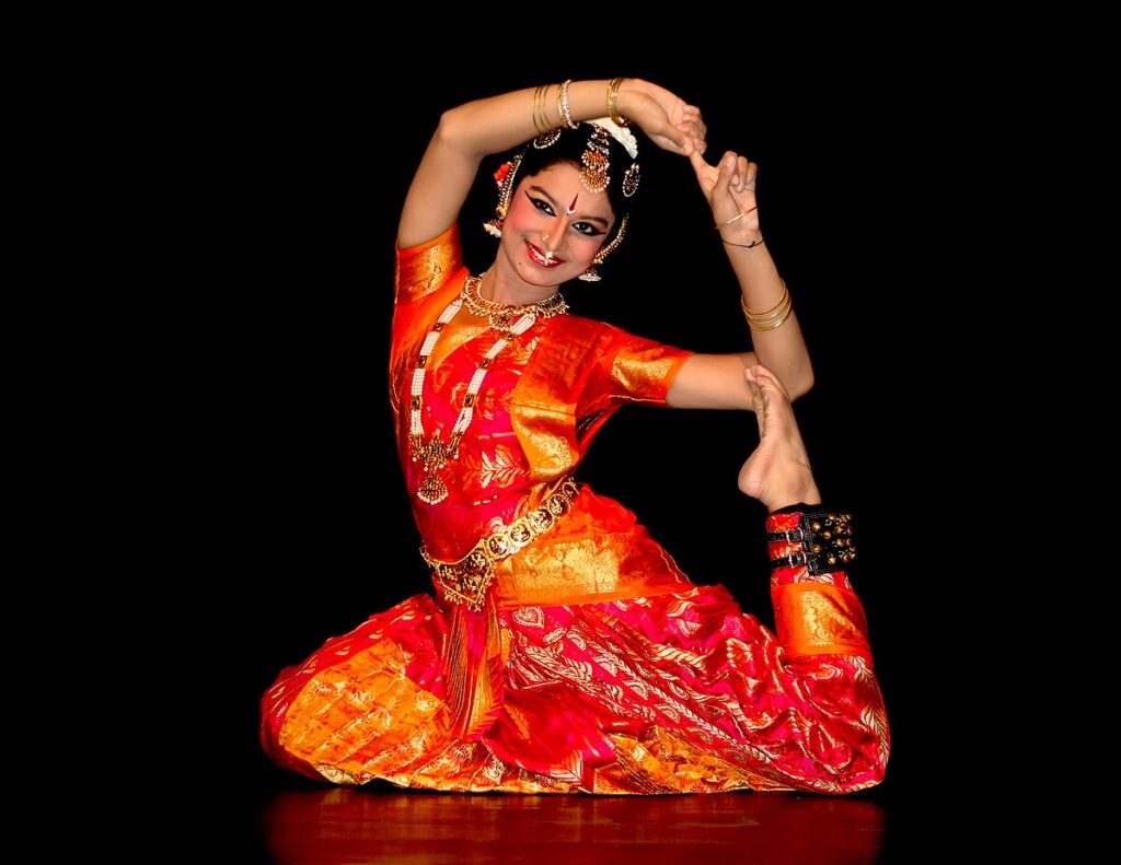 A dancer in an elegant pose performing the classical Indian dance of Bharatanatyam.