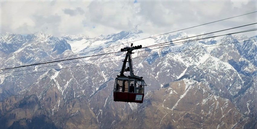 Visitors enjoying a scenic ride inside the cable car cabin on the Auli Ropeway.