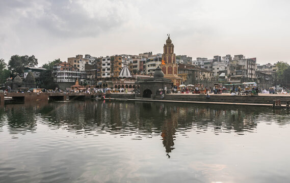 Pilgrims taking a holy dip in the sacred Ramkund on the Godavari River in Nashik.
