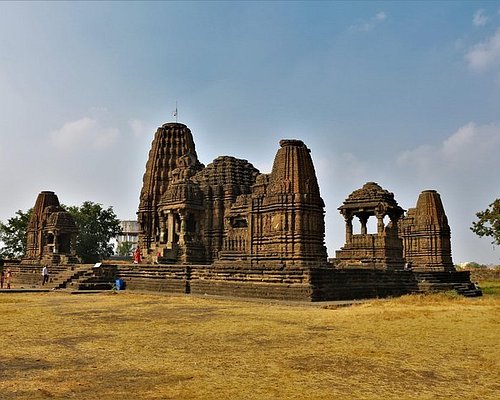 The intricately carved stone shikhara (spire) of the Gondeshwar Temple in Sinnar.