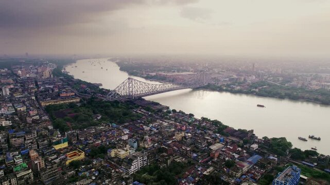 The Hooghly River flowing through Kolkata with city skyline and boats visible along its banks.