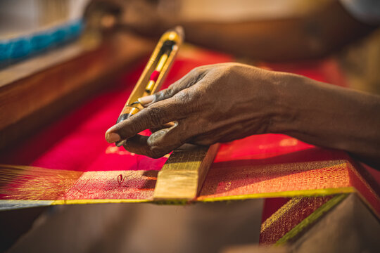Artisan weaving a Kanjivaram silk saree in a local workshop, a cultural place to visit in Kanchipuram.