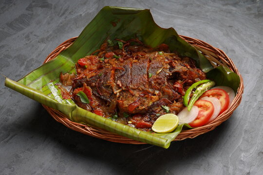 A perfectly grilled Pearl Spot fish (Karimeen) wrapped in banana leaf, ready to serve.