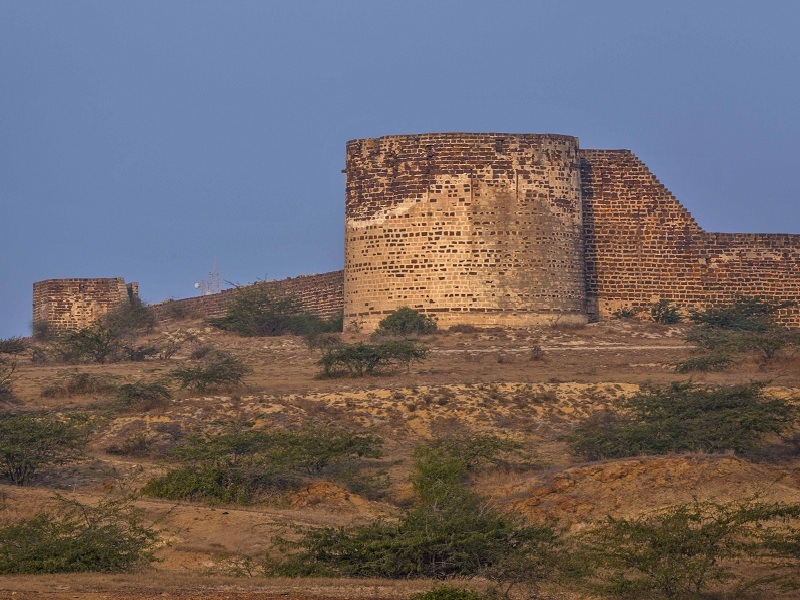 A remote, ruined fort town marking the historical boundary of Sindh, with scenic grandeur.