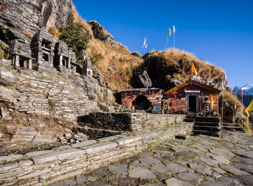 The ancient, stone-built Rudranath Temple set in a remote alpine meadow.