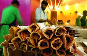 Bustling street food scene near Howrah Station with vendors serving local snacks.