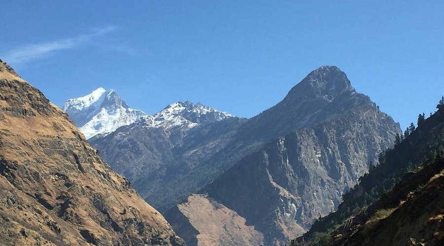 A scenic view of the geothermal Tapovan meadow with steaming hot springs.