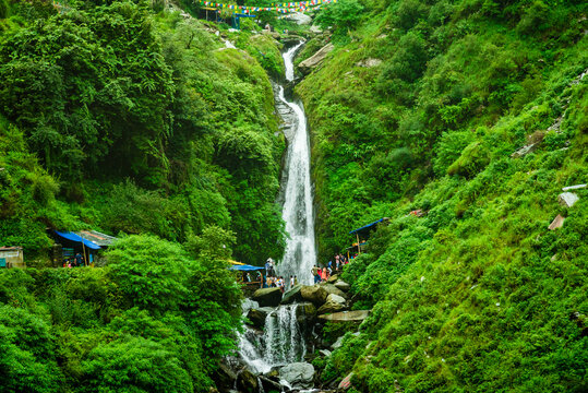 Pilgrims at the ancient Bhagsu Nag Temple with its waterfall near Dharamshala.