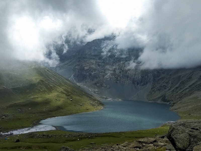 The serene and sacred Gangabal Lake set against towering peaks, accessible from Sonamarg.