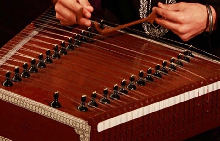 A musician playing traditional Kashmiri folk music in Sonamarg.