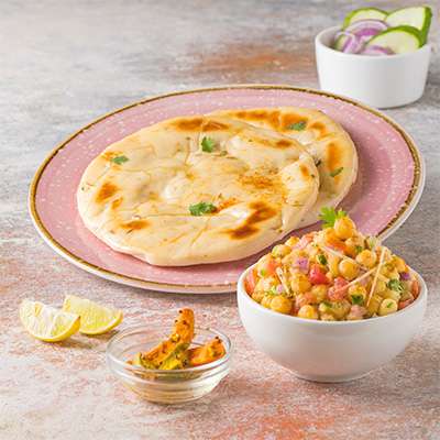 A plate of fluffy Kulcha served with spicy Chana.