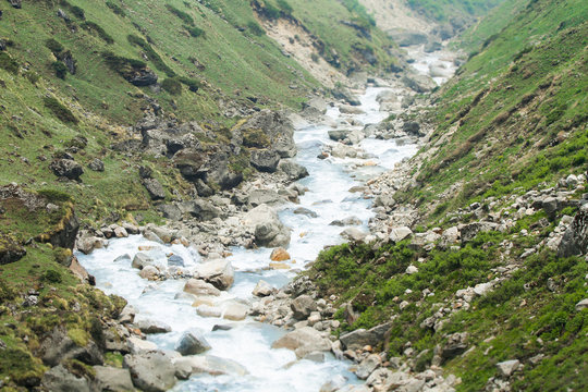 A devotee collecting sacred Mandakini Jal (river water).