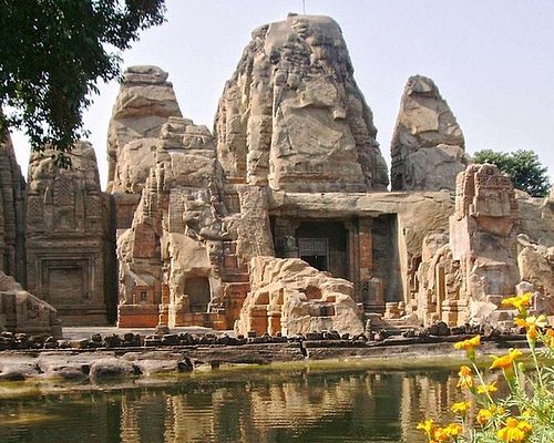 The detailed stone carvings on the ancient Masrur rock-cut temple complex.