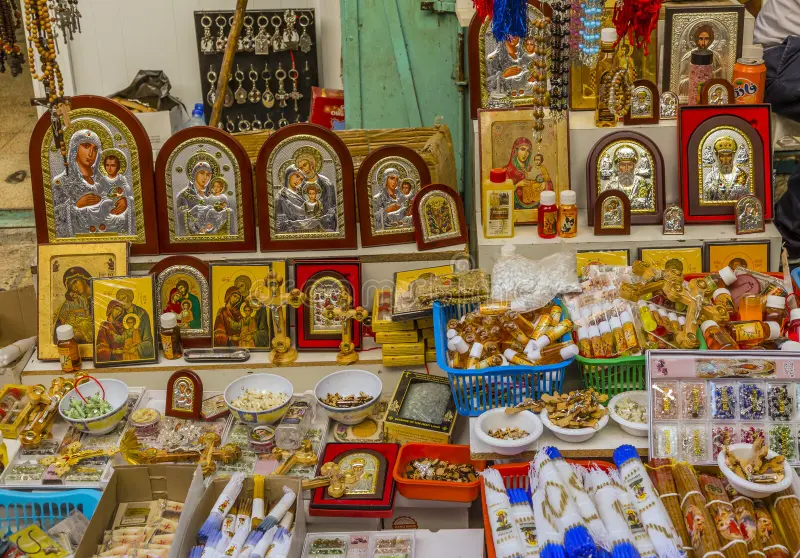 A collection of religious souvenirs including idols and prayeA collection of religious souvenirs including idols and prayer beads.r beads.