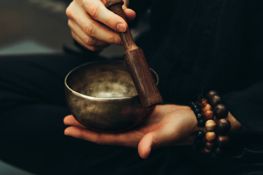 A set of polished Tibetan Singing Bowls and handheld prayer wheels.