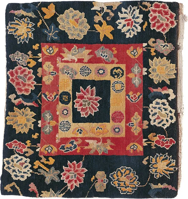 A display of warm Tibetan woolen shawls and intricately patterned carpets.
