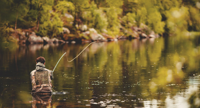 An angler enjoying trout fishing in the clear waters of the Sindh River in Sonamarg.