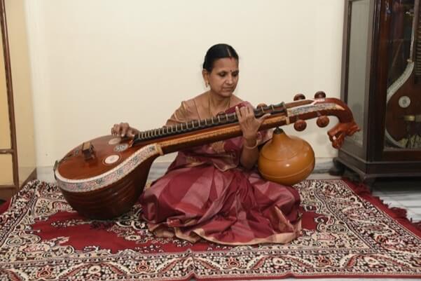 Devotional singer performing Annamacharya Sankeertanas with musical instruments.