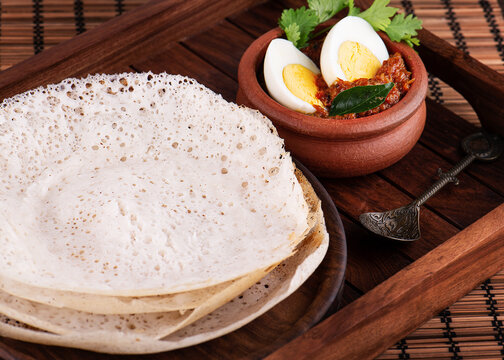 Soft Appam with creamy Ishtu stew in a traditional bowl.