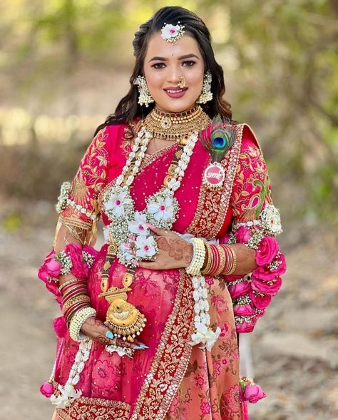 A warm image showing the Simant Puja, a cherished prenatal ritual of Maharashtra where the mother-to-be is blessed and fed sweets.