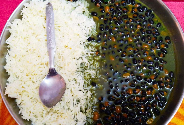 A traditional Bhatt Ki Churkani, a black soybean curry served with rice.