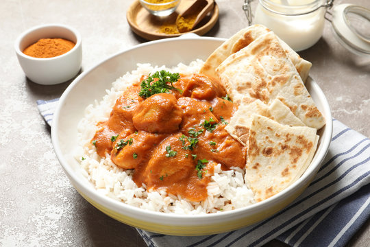 A creamy and rich serving of iconic Butter Chicken, garnished with butter and cream.