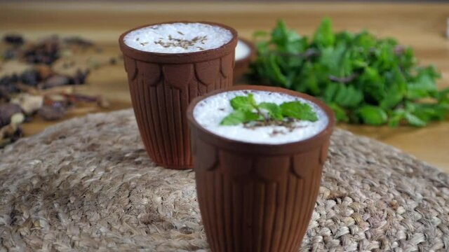 Fresh spiced buttermilk (chaas) served in a traditional glass, flavored with roasted cumin and mint.