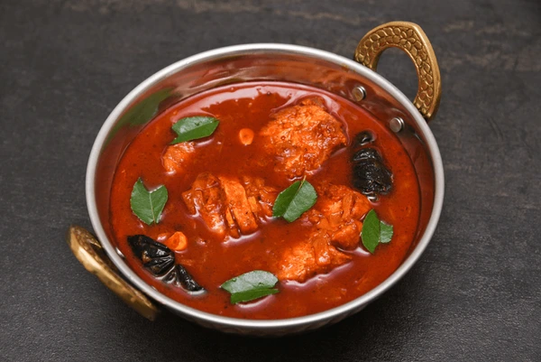 Spicy Chepala Pulusu fish curry simmering in an earthen pot.