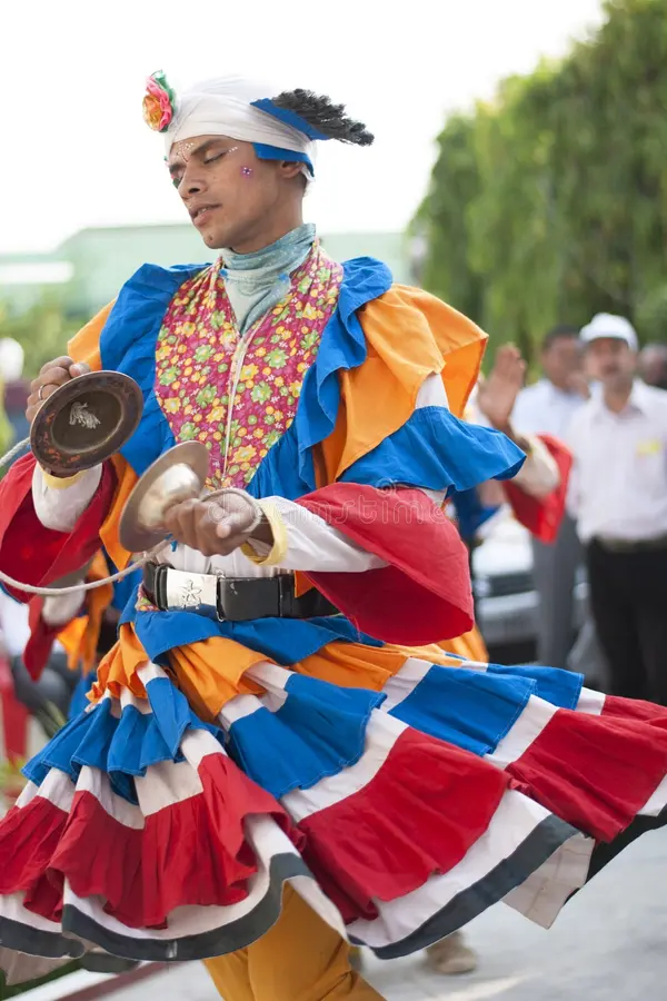 Vibrant Garhwali dancers performing the energetic Chholiya Dance during a festival.