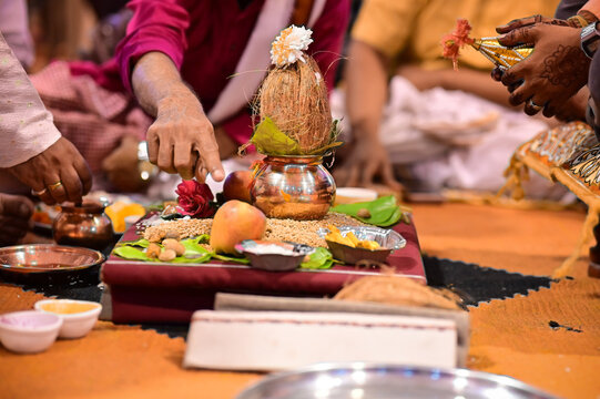 An intimate home scene illustrating the daily Nitya Puja, a core spiritual ritual of Maharashtra involving lamp lighting and offerings.