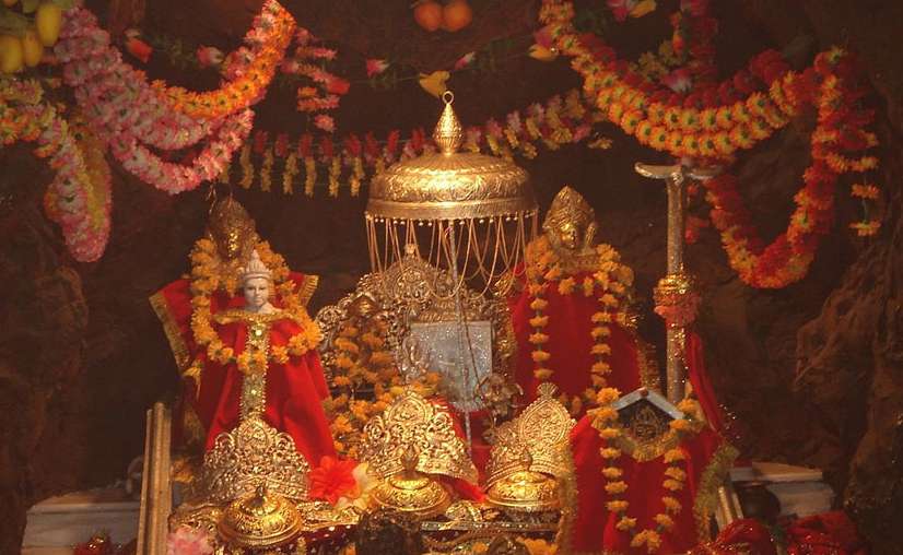 A priest performing the morning Aarti at a temple, representing the daily devotional rituals of Jammu and Kashmir's shrines.