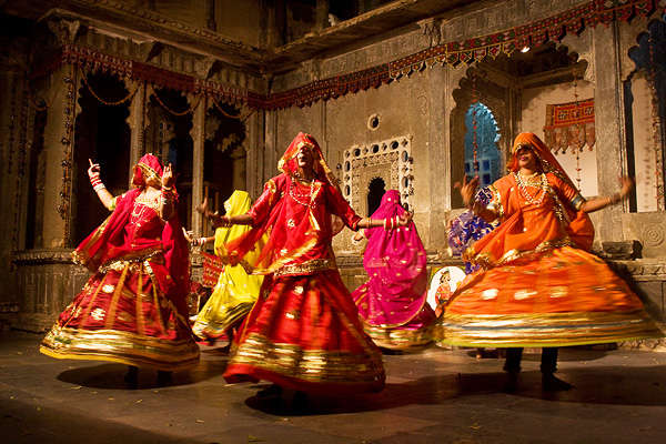 Women in vibrant ghagras performing the graceful Ghoomar dance at a cultural event in Kota.