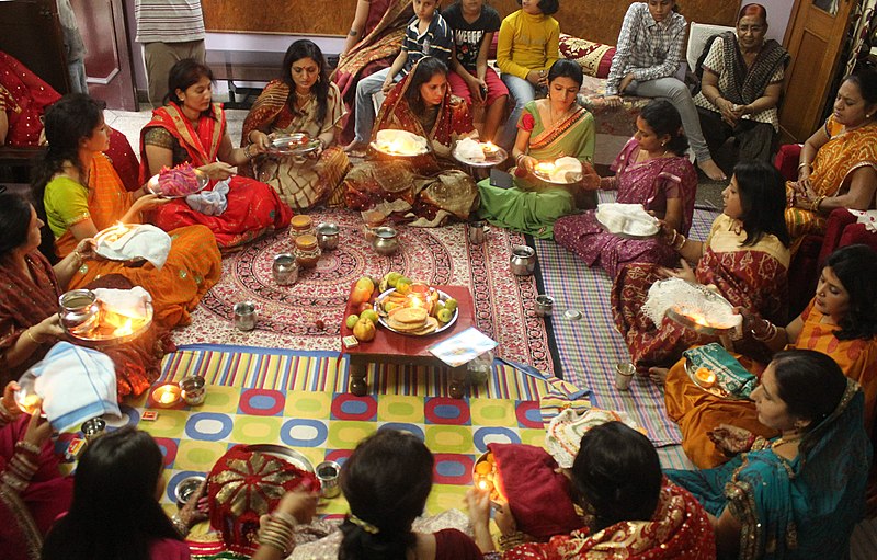 A married woman observing the moon during Karva Chauth, traditional marital rituals of Punjab.