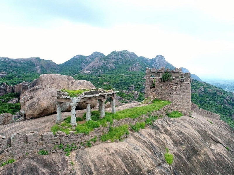 Stone gateways and temple ruins scattered across the Kondaveedu Fort hilltop.