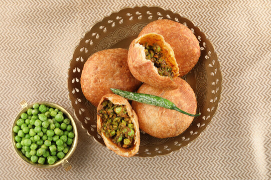 Crispy golden Kota Kachoris served on a plate with green and tamarind chutney.