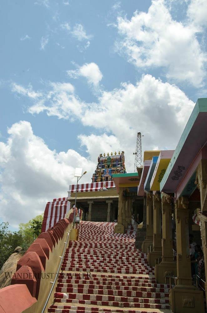 Devotees climbing steps to Kundrakudi Murugan Temple, a popular hill temple place to visit near Chettinad.