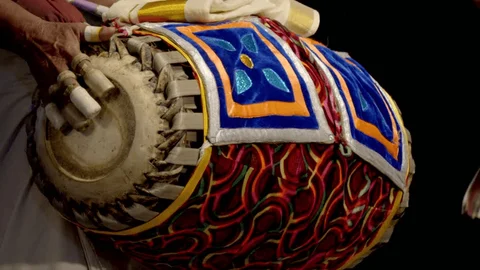 Musicians playing traditional instruments during Mappila Paattu performance.