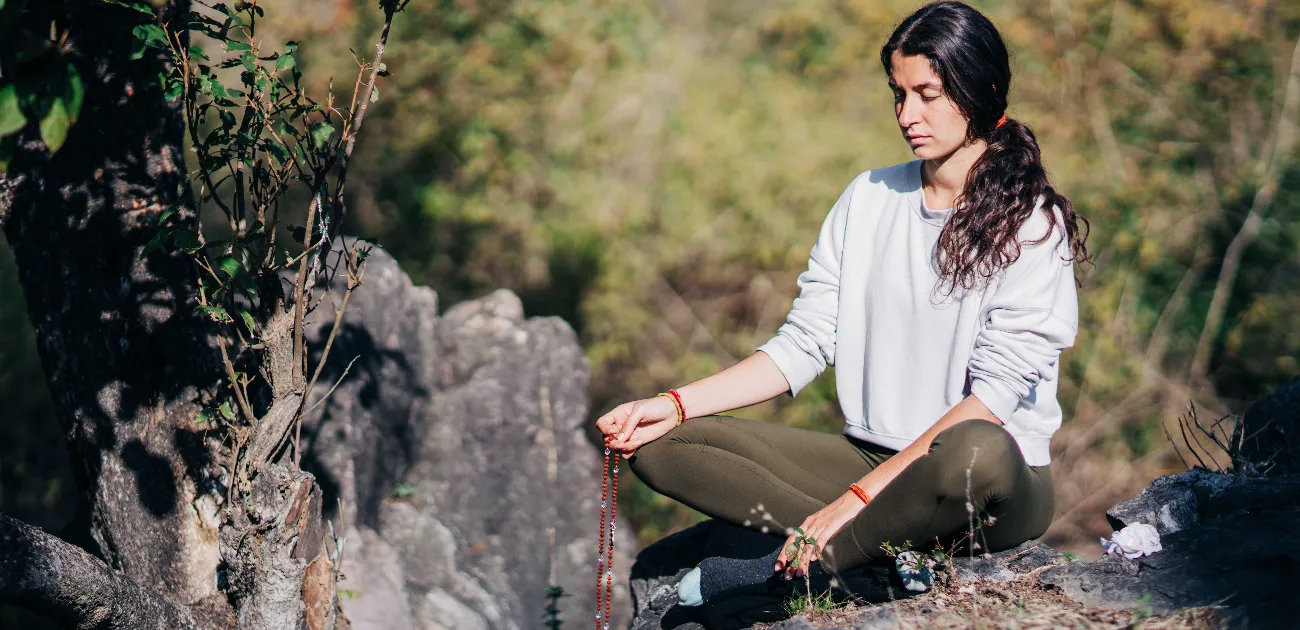 An individual in meditation performing Japa with a mala, representing the personal spiritual rituals of Maharashtra.