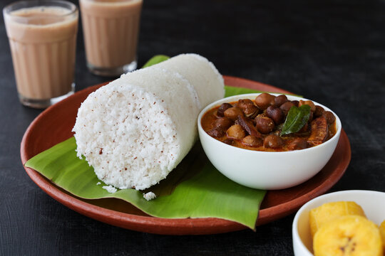 Breakfast plate of Puttu with Kadala Curry and banana.