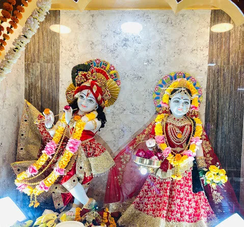 Colorful idols of Radha and Krishna adorned with flowers at this temple, a devotional site among places to visit in Lakhimpur Kheri.