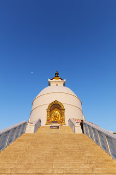 The gleaming white Shanti Stupa against blue skies, a peace pagoda place to visit in Amaravati.