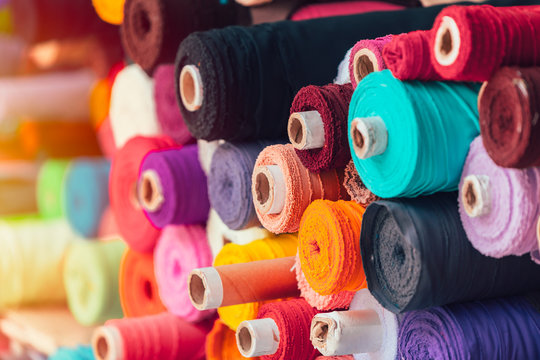 Shoppers browsing vibrant Phulkari textiles and woolens at a bustling market in Ludhiana.