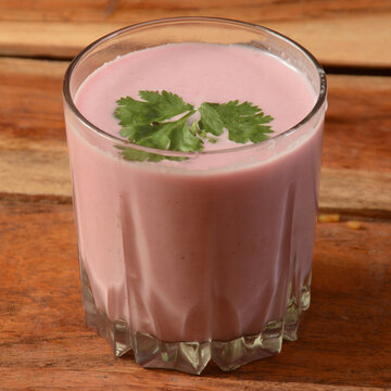 Glass of pink Sol Kadhi beverage made from kokum and coconut milk.