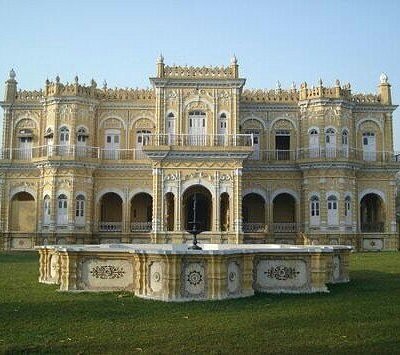 The historic facade of Surat Bhawan Palace showcasing its architectural details.