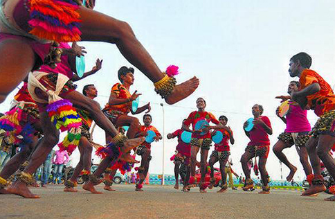 Folk dancers in vibrant costumes performing Tappeta Gullu dance.