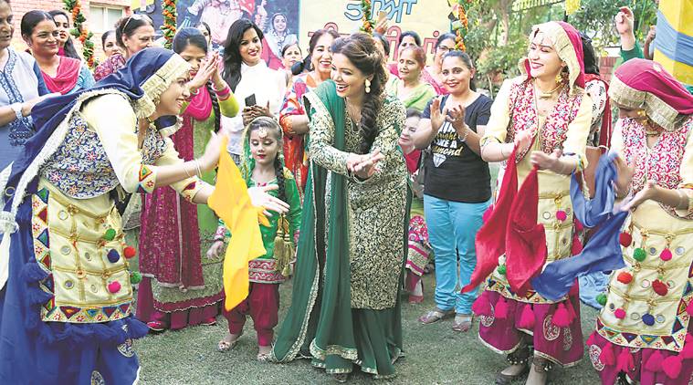 Women dressed in green celebrating Teej, festive monsoon rituals of Punjab.