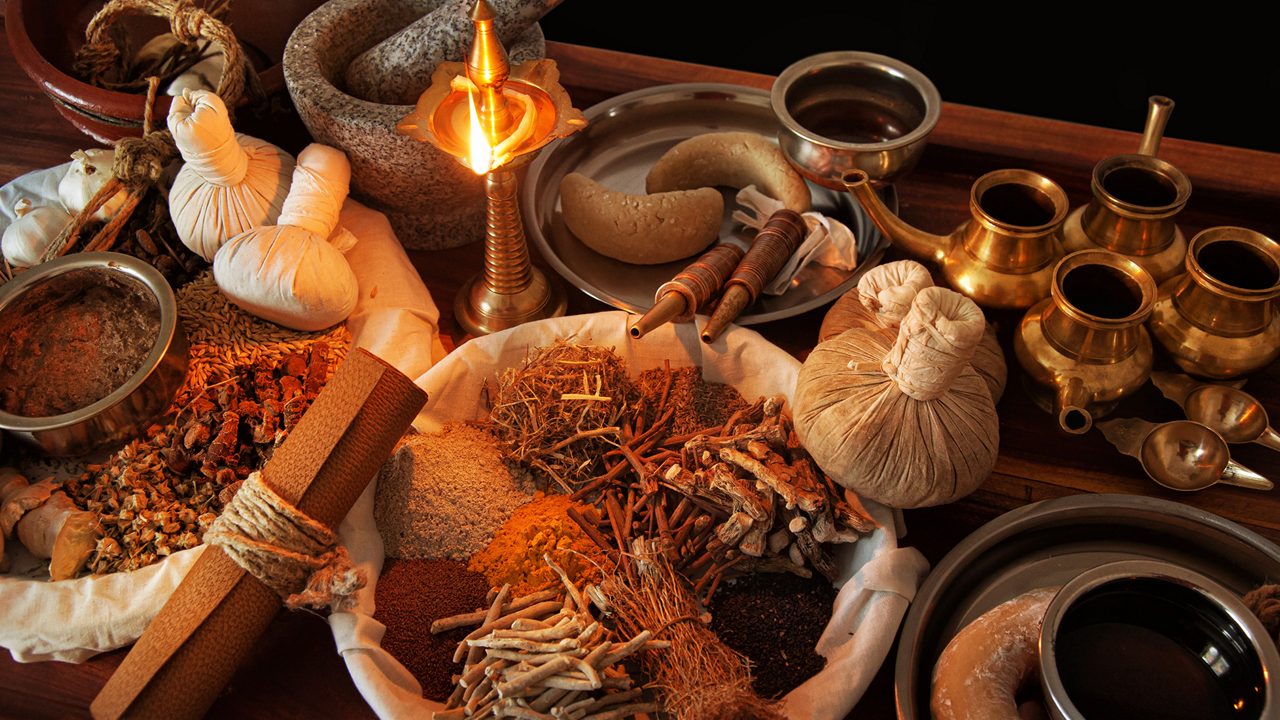 A practitioner preparing Traditional Wellness (Desi Ilaj) treatments.