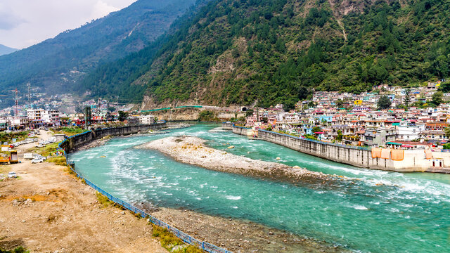 scenic Bhagirathi River flowing through Uttarkashi town with Himalayan foothills in background