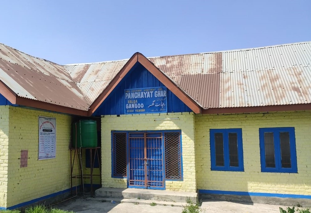 A circle of village elders deliberating a local matter in a traditional Panchayat meeting.