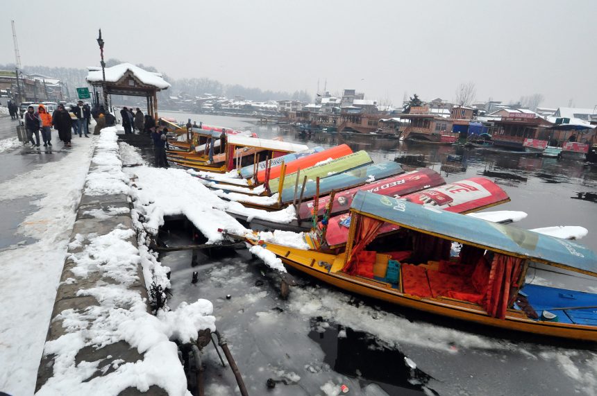 A family gathered around a Kangri (fire pot) for warmth, depicting the essential winter survival rituals of Jammu and Kashmir.